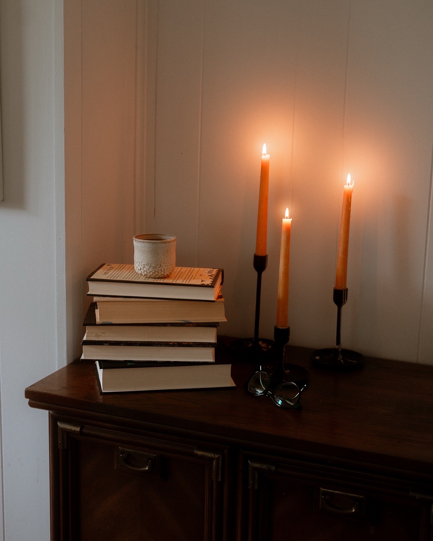 sabbath candles with books stacked
