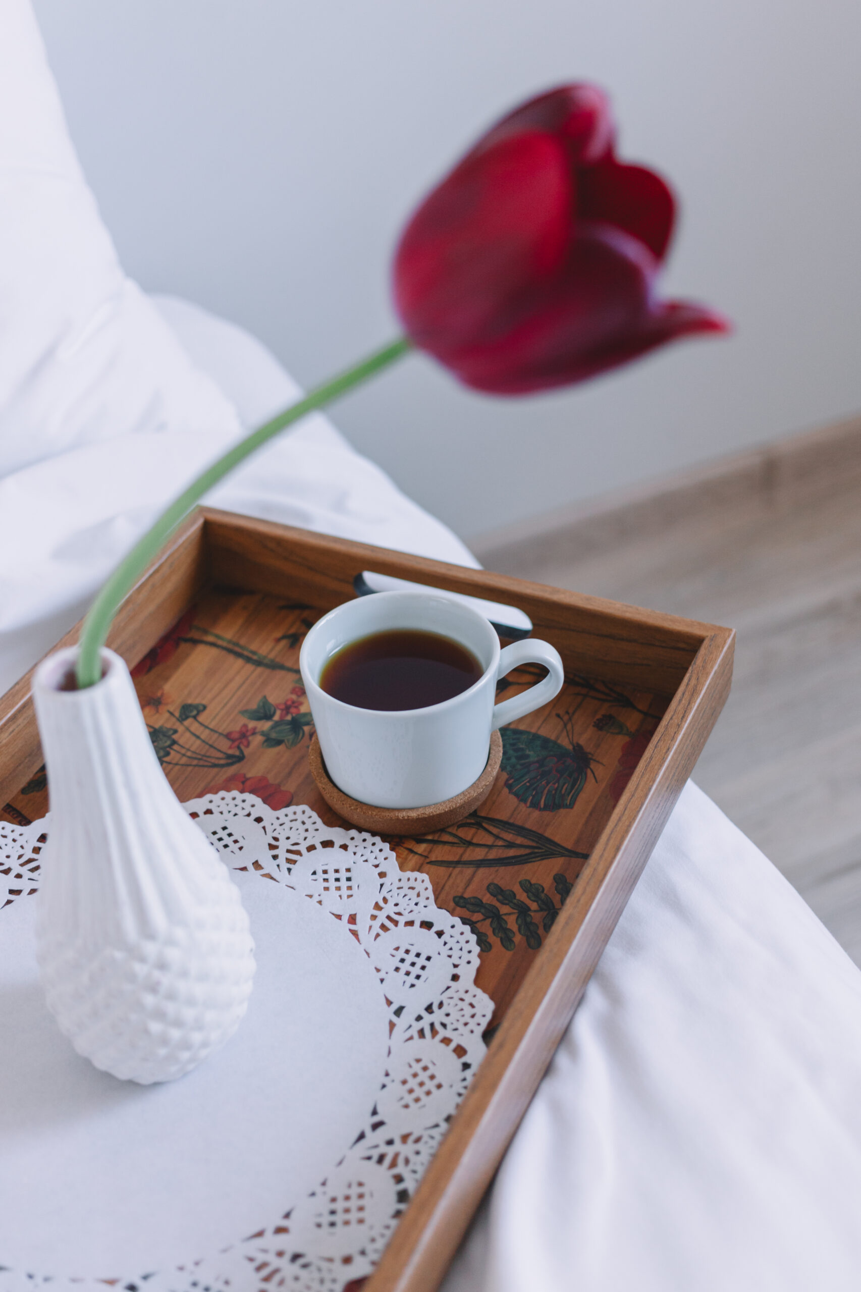 wooden tray with coffee and a flower