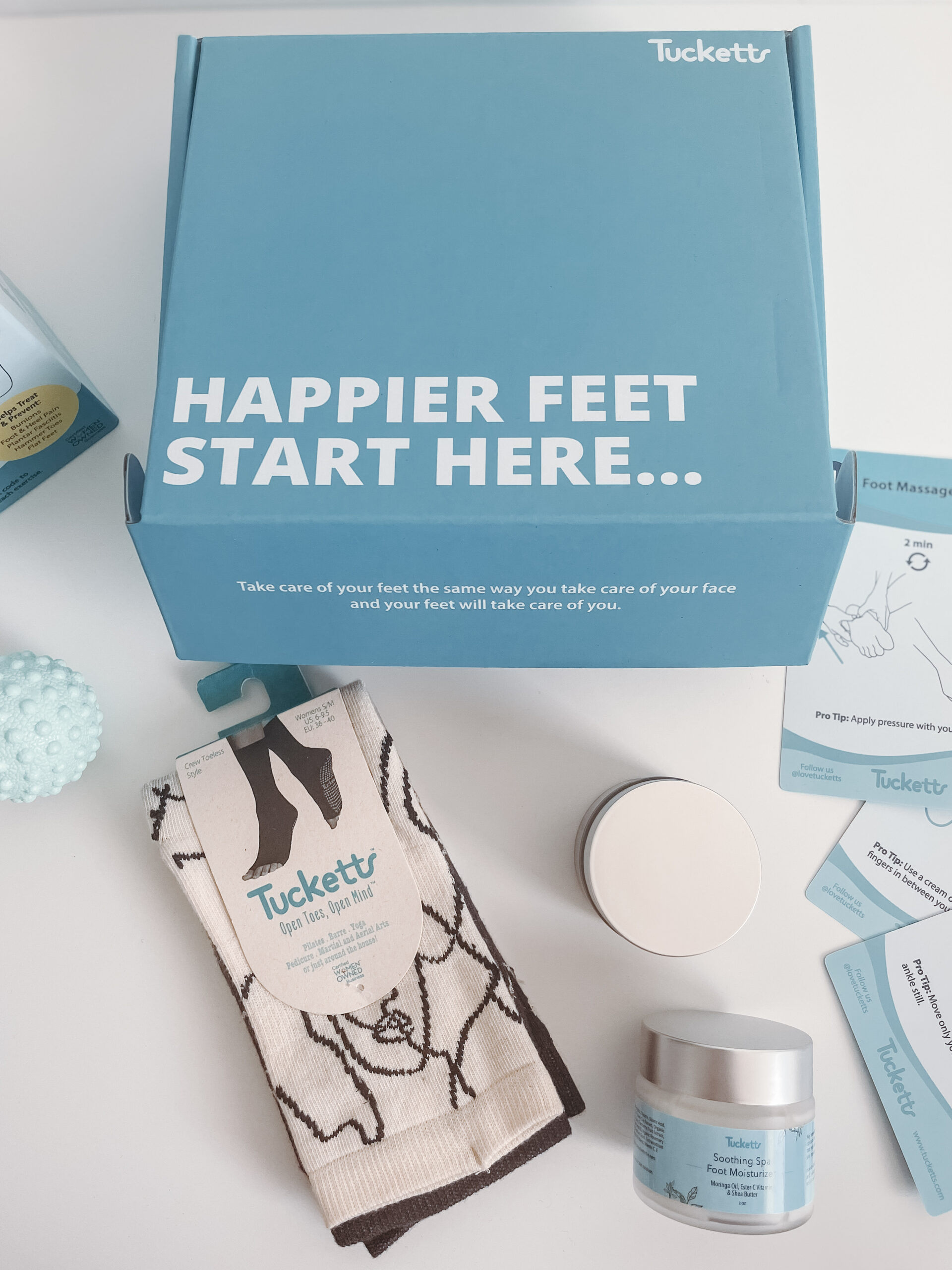 tucketts grip socks and happy feet package on table overlay