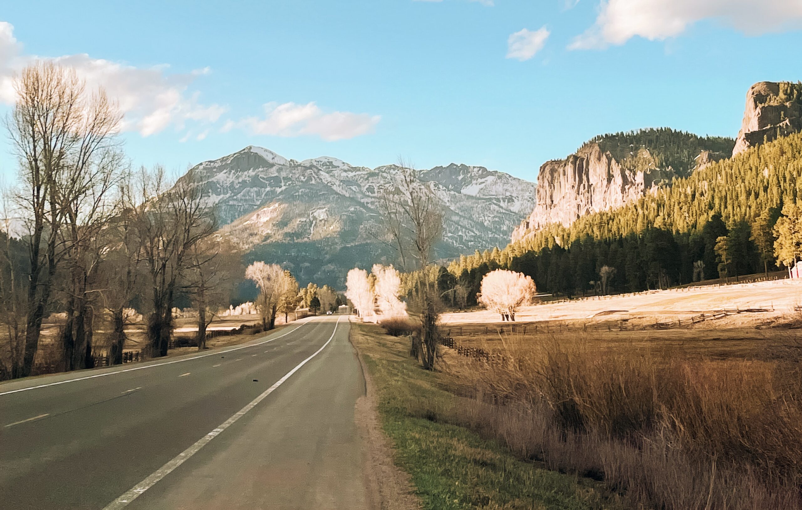 highway road against colorado mountains and cliffsides near a colorado small town (Durango)