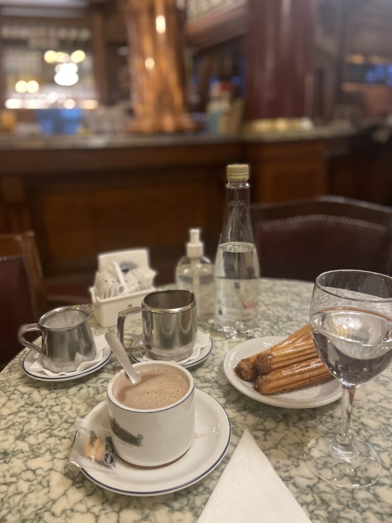famous chocolate and chiros sitting on a table at cafe tortoni